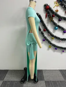 Side view of a sexy mint green two-piece dress set with high slit and tie detail