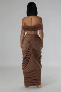 Back view of brown two-piece set featuring off-shoulder top and ruched floor-length skirt