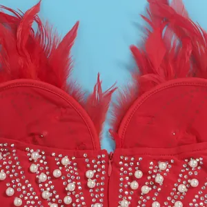 Detail eines sexy roten Kleides mit luxuriösen Federn, Perlen und Strassverzierungen
