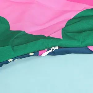Close-up of high quality hidden zipper detail on colorful V-neck patterned dress fabric