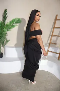 Full view of elegant black off-shoulder pleated maxi skirt and crop top set on model
