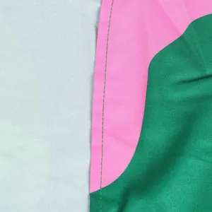 Close-up macro view of the professional stitching and vibrant colorblock fabric of the dress