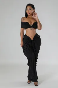 Sexy black two-piece set featuring off-shoulder crop top and ruched floor-length skirt.