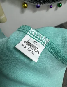 Close-up detail of the inner wash label showing 95% polyester and 5% spandex content