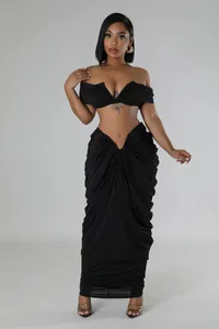 Elegant black two-piece set with off-the-shoulder top and ruched floor-length skirt