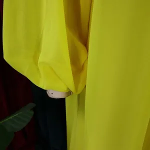 Close-up of yellow chiffon dress showing balloon sleeve detail and soft fabric texture