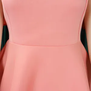 Close-up detail of the waist seam and peplum on a peach pink elegant party dress