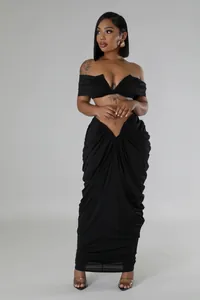 Sexy black two-piece set with strapless crop top and draped v-waist maxi skirt detail.