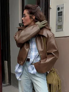 Vintage matte brown faux leather motorcycle jacket styled with plaid shirt and jeans