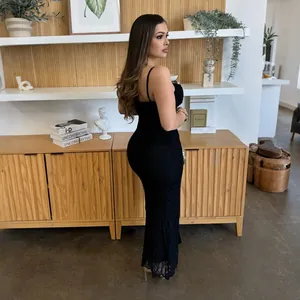 Side profile showing the texture of a long black lace dress with spaghetti straps