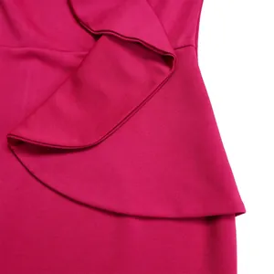 Close-up detail of fuchsia ruffle dress showing elegant design and high-quality fabric texture