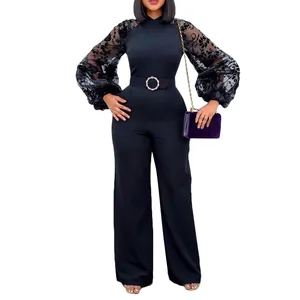 Close-up of elegant black jumpsuit featuring mesh lantern sleeves with floral patterns.