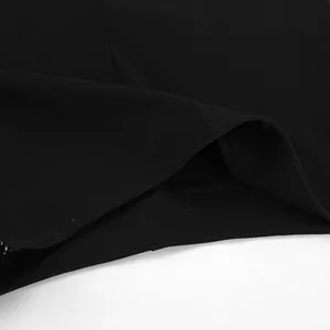 Close-up detail of black high-waisted yoga pants showing stitching and fabric texture