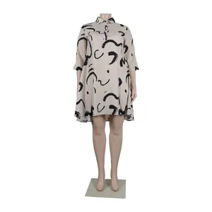 Detail view of beige collared dress with black abstract print on a mannequin.