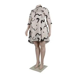 Plus size shirt dress with black abstract brushstroke pattern on beige background