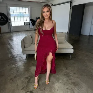 Full length view of a dark red lace maxi dress featuring ruffles and high slit detail
