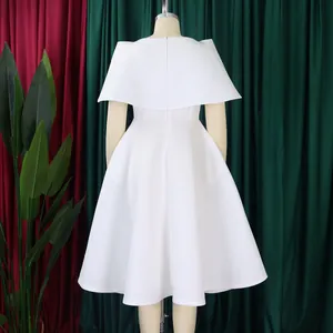 Back view detail of elegant white party dress with cape shoulders and a full flared skirt