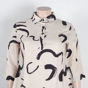 Detailed view of cream shirt dress with black abstract print on a mannequin.