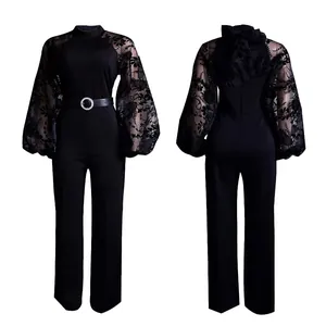 Front and back view of a black jumpsuit with sheer floral mesh lantern sleeves and belt.