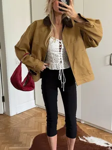 Stylish high-waisted black cropped yoga pants worn with a jacket in a lifestyle setting