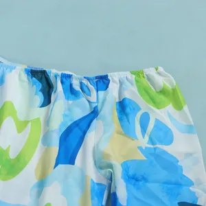 Detailed view of elastic waistband on blue floral print shorts