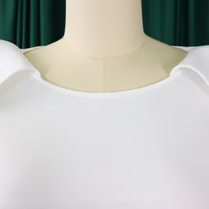 Close-up detail of white elegant banquet dress with unique cape shoulder design.