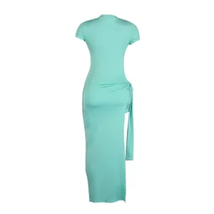 Back view of a mint green stretchy tight midi dress with high slit and tie detail