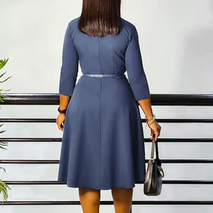 Back view of elegant blue high waist A-line dress featuring slim belt and pleated skirt