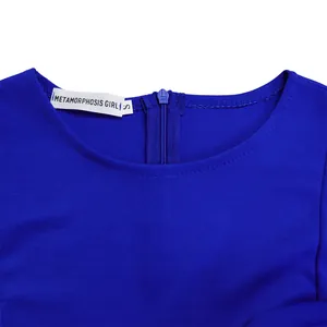 Detail shot of blue dress neckline showing METAMORPHOSIS GIRL tag and blue zipper.