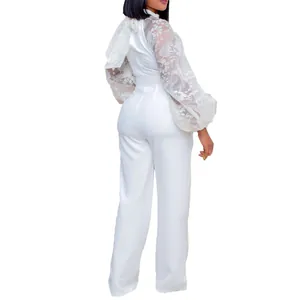 Detail view of a white jumpsuit featuring lace lantern sleeves and wide-leg design