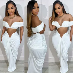 Detailed view of sexy white ruched two-piece skirt set with off-shoulder crop top