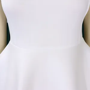 Detailed close-up view of the waist and flared skirt on an elegant white party gown