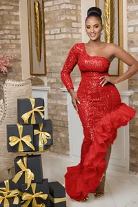 Detail showing a sexy red sequin one-shoulder dress with an asymmetric ruffled mesh hem