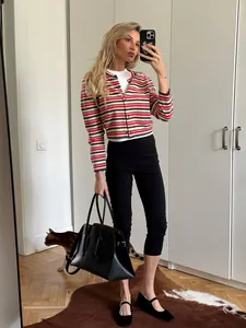 Stylish high-waist black cropped yoga pants shown in a full-body mirror selfie outfit.