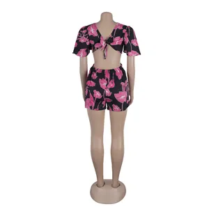 Detailed back view of a black floral cutout jumpsuit featuring ruffle sleeves and a tie-back.