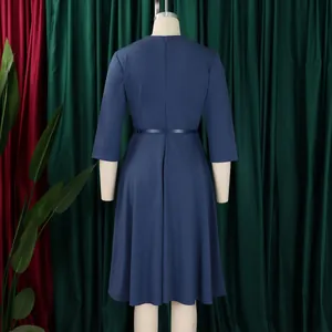 Back view of an elegant navy blue A-line midi dress with flared hem on mannequin