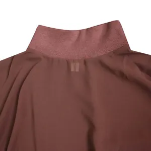 Close-up detail of high ribbed neckline on brown chiffon dress with sheer texture