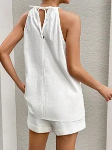 Rear view of white halter neck sleeveless top and shorts set with back slit detail