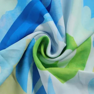 Detailed macro view of vibrant blue and green abstract print fabric showing soft texture