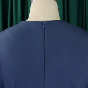 Detailed close-up view of a hidden zipper on the back of a navy blue dress fabric