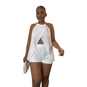 Two-piece white halter neck set with split top and elastic waist shorts