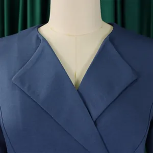 Close-up detail of navy blue elegant V-neck dress with textured fabric on mannequin