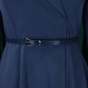 Close-up of navy blue V-neck dress with matching thin belt and textured fabric detail