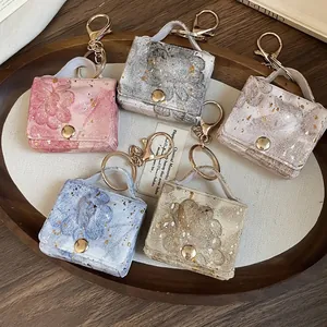 Eleganti portachiavi in pelle a forma di cuore con stampe floreali e dettagli dorati