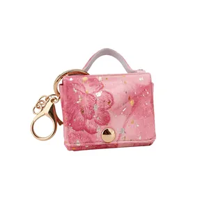 Squisito portachiavi mini borsa in pelle rosa con stampa floreale e eleganti dettagli dorati