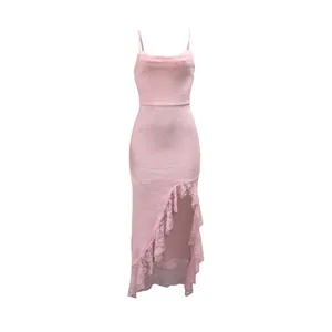 Detailed view of pink lace slip dress with ruffled asymmetrical slit hem
