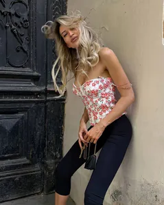 Stylish blonde model wearing black high waist cropped yoga leggings in street setting