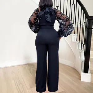 Elegant high neck black jumpsuit featuring mesh lantern sleeves and a large back bow
