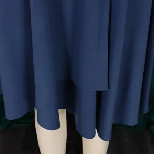 Close-up detail of navy blue maxi dress hemline with elegant pleated fabric texture.