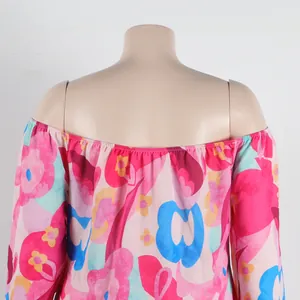 Detail view of an off-the-shoulder floral print dress with vibrant pink and blue patterns.
